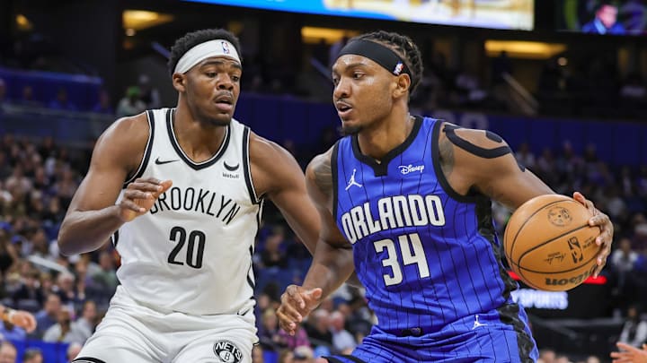 Feb 27, 2024; Orlando, Florida, USA; Orlando Magic center Wendell Carter Jr. (34) drives to the basket against Brooklyn Nets center Day'Ron Sharpe (20) during the first quarter at Amway Center. Mandatory Credit: Mike Watters-Imagn Images