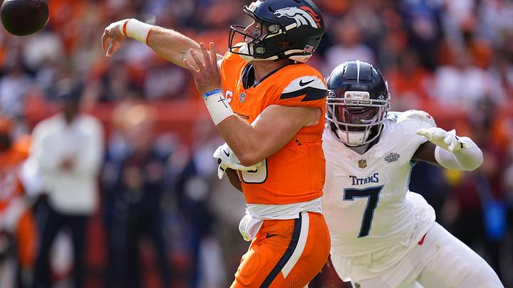 Sep 7, 2025; Denver, Colorado, USA; Denver Broncos quarterback Bo Nix (10) throws the ball past Tennessee Titans linebacker Oluwafemi Oladejo (7) in the second half at Empower Field at Mile High. Mandatory Credit: Ron Chenoy-Imagn Images