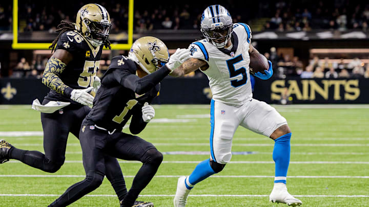 Dec 14, 2025; New Orleans, Louisiana, USA; Carolina Panthers running back Rico Dowdle (5) blocks New Orleans Saints cornerback Alontae Taylor (1) during the second quarter at Caesars Superdome. Mandatory Credit: Stephen Lew-Imagn Images
