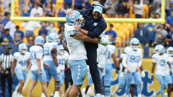 Oct 10, 2026; Pittsburgh, Pennsylvania, USA; North Carolina Tar Heels defensive lineman Melkart Abou Jaoude (9) celebrates with outside linebackers Coach Ty Nichols (right) after a defensive stop against the Pittsburgh Panthers during the fourth quarter at Acrisure Stadium. Mandatory Credit: Charles LeClaire-Imagn Images Oct 10, 2026; Pittsburgh, Pennsylvania, USA; North Carolina Tar Heels defensive lineman Melkart Abou Jaoude (9) celebrates with outside linebackers Coach Ty Nichols (right) after a defensive stop against the Pittsburgh Panthers during the fourth quarter at Acrisure Stadium. Mandatory Credit: Charles LeClaire-Imagn Images
