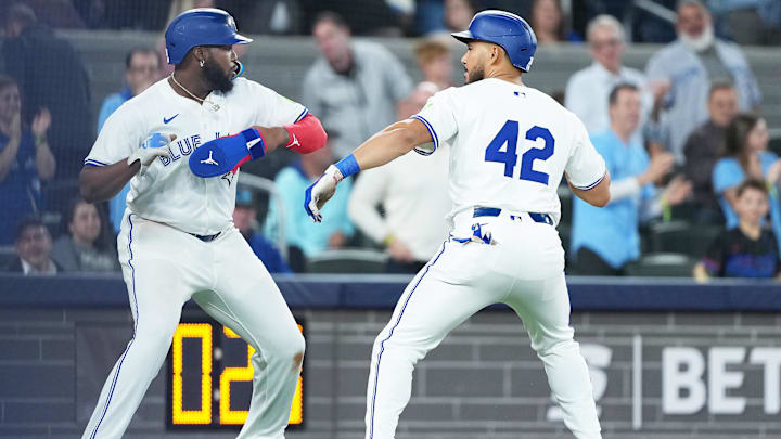 Apr 15, 2025; Toronto, Ontario, CAN; Toronto Blue Jays designated hitter Anthony Santander (25) hits a three run home run and celebrates with first baseman Vladimir Guerrero Jr. (27) against the Atlanta Braves during the fifth inning at Rogers Centre. All players wore #42 for Jackie Robinson Day.