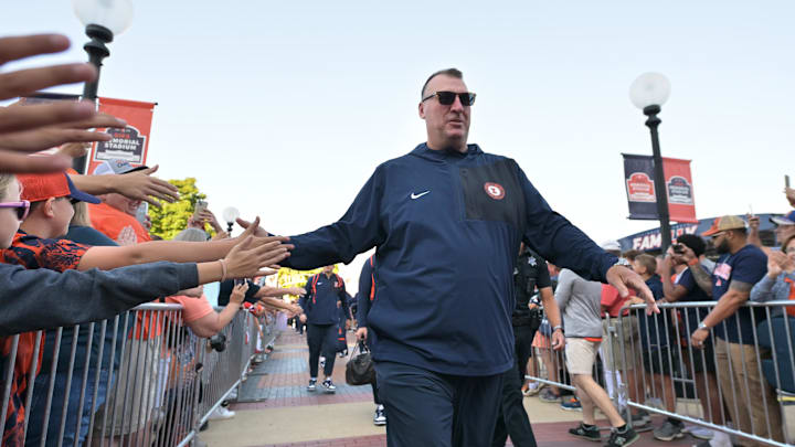 Sep 27, 2025; Champaign, Illinois, USA;  Illinois Fighting Illini head coach Bret Bielema leads his team down the Illini Walk before an NCAA football game with the Southern California Trojans at Memorial Stadium. Mandatory Credit: Ron Johnson-Imagn Images