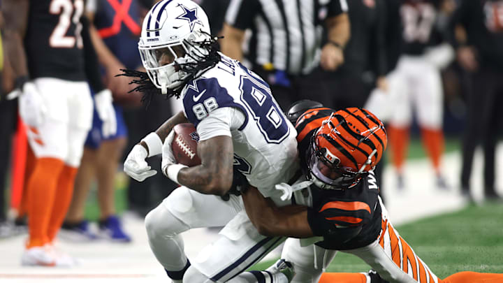 Dec 9, 2024; Arlington, Texas, USA; Dallas Cowboys wide receiver CeeDee Lamb (88) is tackled by Cincinnati Bengals cornerback Marco Wilson (42) in the first quarter at AT&T Stadium. Mandatory Credit: Tim Heitman-Imagn Images