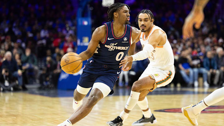Jan 22, 2024; Philadelphia, Pennsylvania, USA; Philadelphia 76ers guard Tyrese Maxey (0) dribbles past San Antonio Spurs guard Tre Jones (33) during the first quarter at Wells Fargo Center. Mandatory Credit: Bill Streicher-Imagn Images