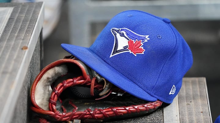 Apr 16, 2025; Toronto, Ontario, CAN; A Toronto Blue Jays hat and glove in the dugout during a game against the Atlanta Braves at Rogers Centre. Mandatory Credit: John E. Sokolowski-Imagn Images Apr 16, 2025; Toronto, Ontario, CAN; A Toronto Blue Jays hat and glove in the dugout during a game against the Atlanta Braves at Rogers Centre. Mandatory Credit: John E. Sokolowski-Imagn Images