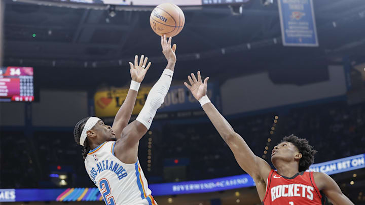 Oct 9, 2024; Oklahoma City, Oklahoma, USA; Oklahoma City Thunder guard Shai Gilgeous-Alexander (2) shoots over Houston Rockets forward Amen Thompson (1) during the second quarter at Paycom Center. Mandatory Credit: Alonzo Adams-Imagn Images
