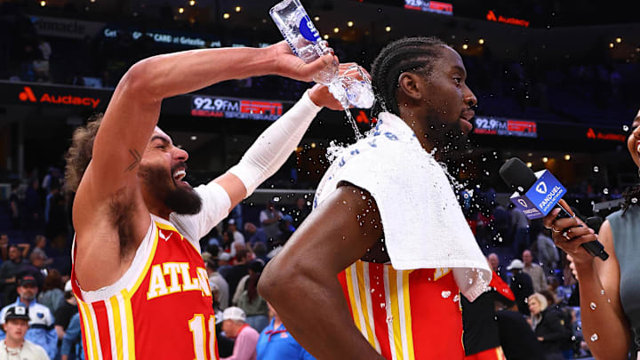 Mar 3, 2025; Memphis, Tennessee, USA; Atlanta Hawks guard Trae Young (11) dumps water on guard Caris LeVert (3) after defeating the Memphis Grizzlies at FedExForum. Mandatory Credit: Petre Thomas-Imagn Images