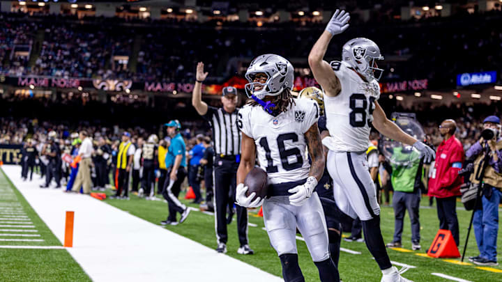 Dec 29, 2024; New Orleans, Louisiana, USA; Las Vegas Raiders wide receiver Jakobi Meyers (16) runs in from a touchdown against New Orleans Saints cornerback Alontae Taylor (1) during the first half at Caesars Superdome. Mandatory Credit: Stephen Lew-Imagn Images Dec 29, 2024; New Orleans, Louisiana, USA; Las Vegas Raiders wide receiver Jakobi Meyers (16) runs in from a touchdown against New Orleans Saints cornerback Alontae Taylor (1) during the first half at Caesars Superdome. Mandatory Credit: Stephen Lew-Imagn Images