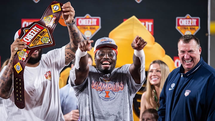 Dec 31, 2024; Orlando, FL, USA; Illinois Fighting Illini running back Josh McCray (6) celebrates winning the MVP after the game against the South Carolina Gamecocks at Camping World Stadium. Mandatory Credit: Jeremy Reper-Imagn Images Dec 31, 2024; Orlando, FL, USA; Illinois Fighting Illini running back Josh McCray (6) celebrates winning the MVP after the game against the South Carolina Gamecocks at Camping World Stadium. Mandatory Credit: Jeremy Reper-Imagn Images