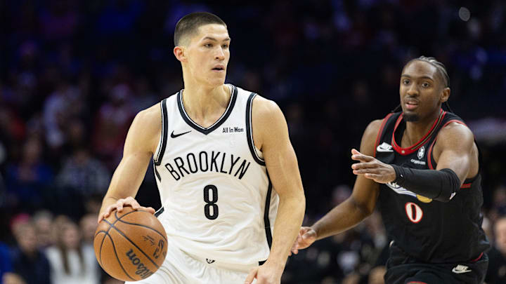 Dec 23, 2025; Philadelphia, Pennsylvania, USA; Brooklyn Nets guard Egor Demin (8) dribbles front of Philadelphia 76ers guard Tyrese Maxey (0) during the first quarter at Xfinity Mobile Arena. Mandatory Credit: Bill Streicher-Imagn Images