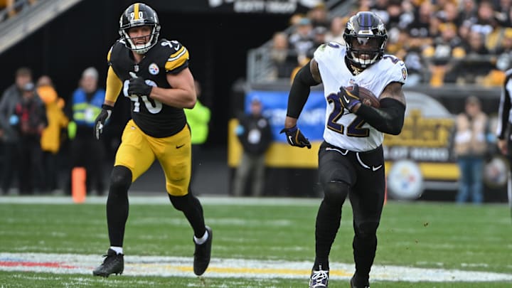 Nov 17, 2024; Pittsburgh, Pennsylvania, USA; Baltimore Ravens running back Derrick Henry (22) gains yardage while being chased by Pittsburgh Steelers linebacker T.J. Watt (90) during the second quarter at Acrisure Stadium. Mandatory Credit: Barry Reeger-Imagn Images