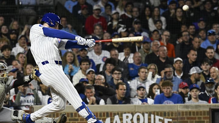 May 12, 2025; Chicago, Illinois, USA;  Chicago Cubs outfielder Kyle Tucker (30) hits an RBI triple against the Miami Marlins during the fifth inning at Wrigley Field.