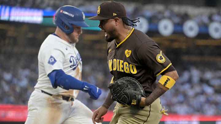 Oct 6, 2024; Los Angeles, California, USA; San Diego Padres first baseman Luis Arraez (4) reacts after an out against Los Angeles Dodgers third baseman Max Muncy (13) in the fourth inning during game two of the NLDS for the 2024 MLB Playoffs at Dodger Stadium. Mandatory Credit: Jayne Kamin-Oncea-Imagn Images