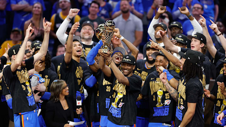 Jun 22, 2025; Oklahoma City, Oklahoma, USA; Oklahoma City Thunder forward Jalen Williams (8) holds up the Bill Russell NBA Finals MVP trophy after winner Oklahoma City Thunder guard Shai Gilgeous-Alexander hands it to him at the end of game seven of the 2025 NBA Finals against the Indiana Pacers at Paycom Center. Mandatory Credit: Alonzo Adams-Imagn Images