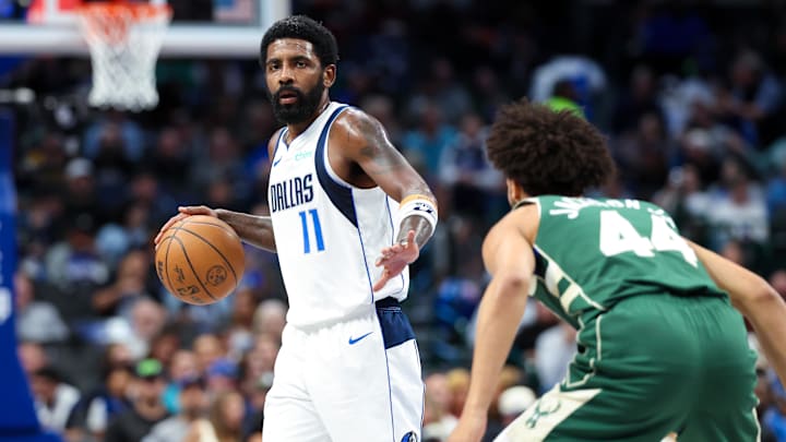 Oct 17, 2024; Dallas, Texas, USA; Dallas Mavericks guard Kyrie Irving (11) dribbles as Milwaukee Bucks guard Andre Jackson Jr. (44) defends during the first half at American Airlines Center. Mandatory Credit: Kevin Jairaj-Imagn Images