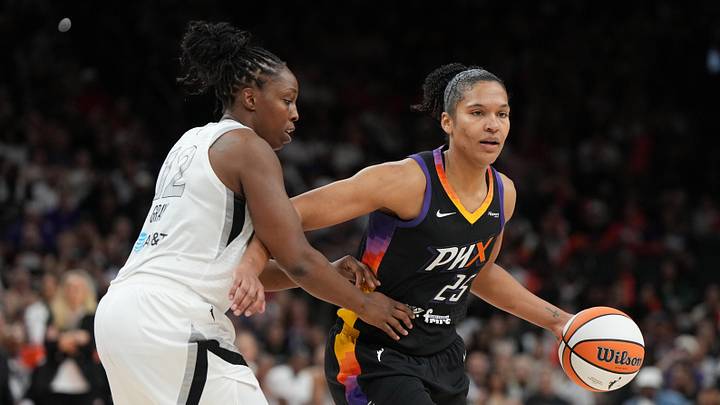 Jun 29, 2025; Phoenix, Arizona, USA; Phoenix Mercury forward Alyssa Thomas (25) shields the ball from Las Vegas Aces guard Chelsea Gray (12) in the second half at Footprint Center. Mandatory Credit: Rick Scuteri-Imagn Images