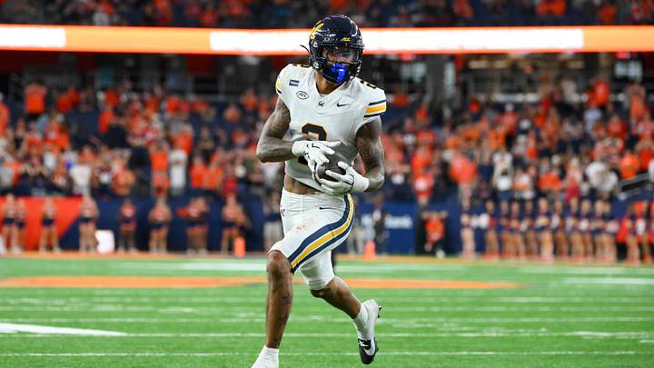 Cal's Kingston Lopa on his way to a touchdown after his second of three interceptions