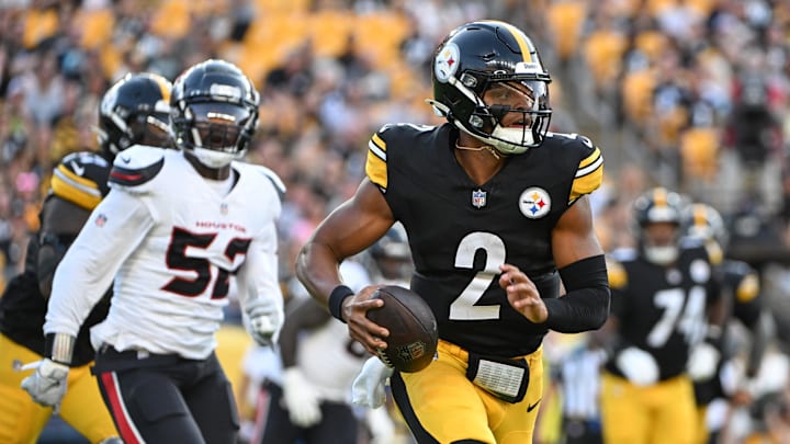 Aug 9, 2024; Pittsburgh, Pennsylvania, USA; Pittsburgh Steelers quarterback Justin Fields (2) runs away from Houston Texans defensive end Jerry Hughes during the first quarter at Acrisure Stadium. Aug 9, 2024; Pittsburgh, Pennsylvania, USA; Pittsburgh Steelers quarterback Justin Fields (2) runs away from Houston Texans defensive end Jerry Hughes during the first quarter at Acrisure Stadium.
