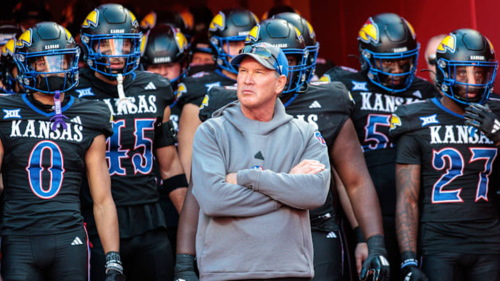 Nov 9, 2024; Kansas City, Missouri, USA; Kansas Jayhawks coach Lance Leipold leads the team onto the field for the game against the Iowa State Cyclones at GEHA Field at Arrowhead Stadium. Mandatory Credit: William Purnell-Imagn Images