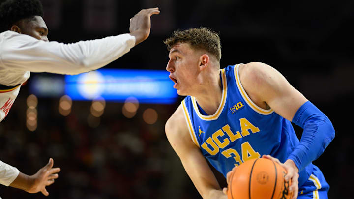 Jan 10, 2025; College Park, Maryland, USA; UCLA Bruins forward Tyler Bilodeau (34) handles the ball against Maryland Terrapins center Derik Queen (25) during the first half at Xfinity Center. Mandatory Credit: Reggie Hildred-Imagn Images