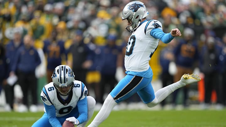 Nov 2, 2025; Green Bay, Wisconsin, USA; Carolina Panthers place kicker Ryan Fitzgerald (10) kicks a game-winning field goal out of the hold from punter Sam Martin (6) during the fourth quarter against the Green Bay Packers  at Lambeau Field. Mandatory Credit: Jeff Hanisch-Imagn Images