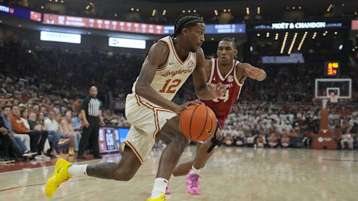 Mar 8, 2025; Austin, Texas, USA; Texas Longhorns guard Tramon Mark (12) drives past Oklahoma Sooners forward Jalon Moore (14) during the first half at Moody Center. Mandatory Credit: Scott Wachter-Imagn Images