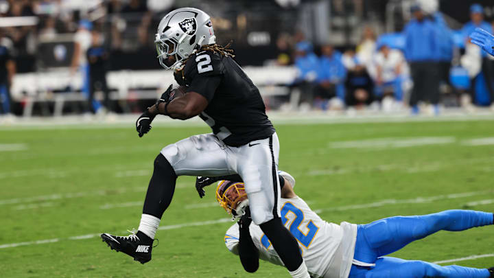 Sep 15, 2025; Paradise, Nevada, USA; Las Vegas Raiders running back Ashton Jeanty (2) evades a tackle from Los Angeles Chargers safety Alohi Gilman (32) during the first quarter at Allegiant Stadium. Mandatory Credit: Kiyoshi Mio-Imagn Images Sep 15, 2025; Paradise, Nevada, USA; Las Vegas Raiders running back Ashton Jeanty (2) evades a tackle from Los Angeles Chargers safety Alohi Gilman (32) during the first quarter at Allegiant Stadium. Mandatory Credit: Kiyoshi Mio-Imagn Images