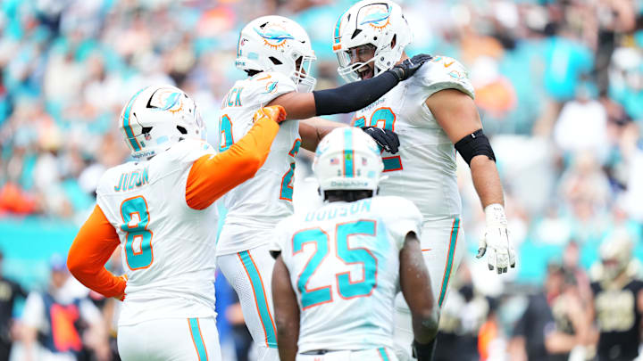 Miami Dolphins defensive tackle Zach Sieler (92) reacts with safety Minkah Fitzpatrick (29) after forcing a fumble against the New Orleans Saints during the first half at Hard Rock Stadium.