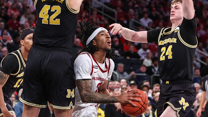 Arkansas Razorbacks guard Boogie Fland (2) drives against Michigan Wolverines forwards Will Tschetter (42) and Sam Walters (24) at Madison Square Garden. Arkansas Razorbacks guard Boogie Fland (2) drives against Michigan Wolverines forwards Will Tschetter (42) and Sam Walters (24) at Madison Square Garden.