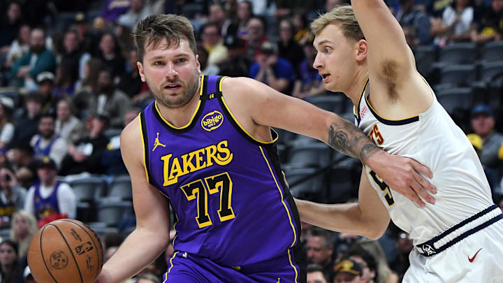 Feb 22, 2025; Denver, Colorado, USA; Los Angeles Lakers guard Luka Doncic (77) drives to the basket against Denver Nuggets forward Hunter Tyson (5) during the second half at Ball Arena. Mandatory Credit: Christopher Hanewinckel-Imagn Images