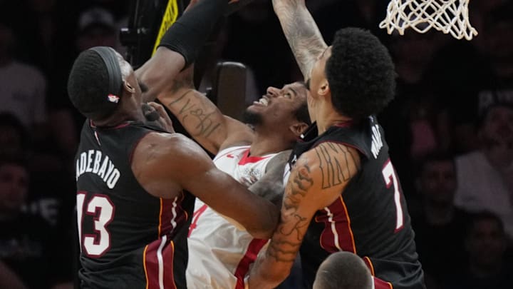 Mar 21, 2025; Miami, Florida, USA;  Miami Heat center Kel'el Ware (7) blocks the shot of Houston Rockets guard Jalen Green (4) as center Bam Adebayo (13) closes in during the second half at Kaseya Center. Mandatory Credit: Jim Rassol-Imagn Images