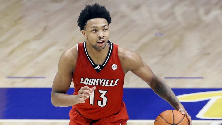 Dec 22, 2020; Pittsburgh, Pennsylvania, USA;  Louisville Cardinals guard David Johnson (13) dribbles the ball against the Pittsburgh Panthers at the Petersen Events Center.