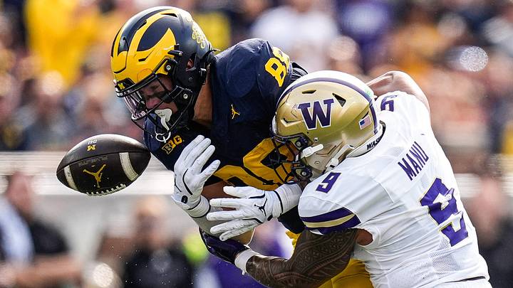 Michigan tight end Deakon Tonielli (88) takes a hit from Husky linebacker Jacob Manu in their 2025 game. Michigan tight end Deakon Tonielli (88) takes a hit from Husky linebacker Jacob Manu in their 2025 game.