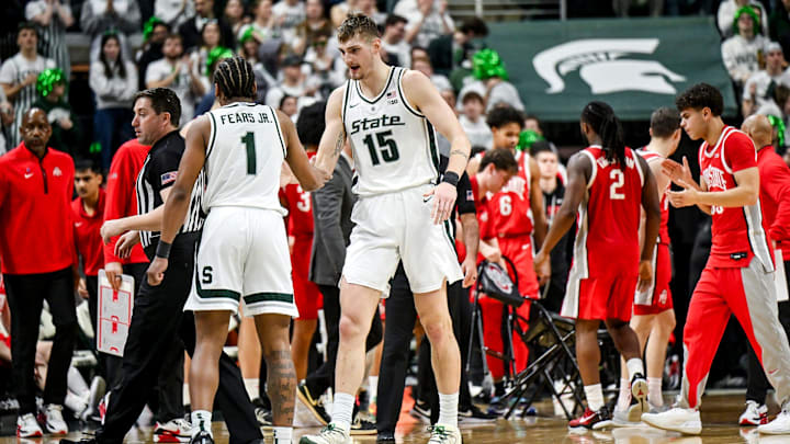 Michigan State's Carson Cooper, right, slaps hands with Jeremy Fears Jr. after a timeout during the second half in the game against an Ohio State on Sunday, Feb. 22, 2026, at the Breslin Center in East Lansing. Michigan State's Carson Cooper, right, slaps hands with Jeremy Fears Jr. after a timeout during the second half in the game against an Ohio State on Sunday, Feb. 22, 2026, at the Breslin Center in East Lansing.
