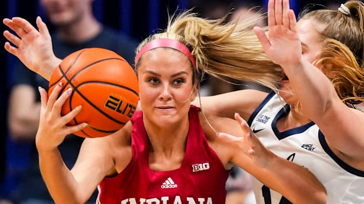 Indiana Hoosiers guard Sydney Parrish (33) recovers the ball against Butler Bulldogs forward Jocelyn Land (14) on Wednesday, Nov. 13, 2024, during a women’s basketball game between the Butler Bulldogs and the Indiana Hoosiers at Hinkle Fieldhouse in Indianapolis.