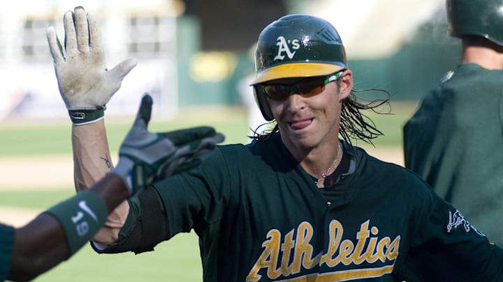 September 30, 2012; Oakland, CA, USA; Oakland Athletics right fielder Josh Reddick (16) high fives second baseman Jemile Weeks (19) (left) after hitting a home run during the eighth inning at O.co Coliseum.  Mandatory Credit: Ed Szczepanski-Imagn Images