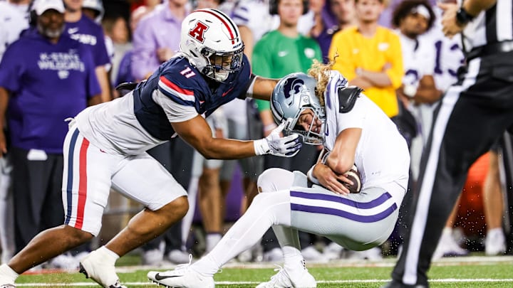 Sep 12, 2025; Tucson, Arizona, USA; Arizona Wildcats linebacker Jabari Mann (11) tackles Kansas State Wildcats quarterback Avery Johnson (2) during the fourth quarter of the game at Arizona Stadium. 