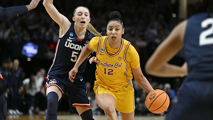 Apr 1, 2024; Portland, OR, USA; USC Trojans guard JuJu Watkins (12) drives to the basket during the second half against UConn Huskies guard Paige Bueckers (5) in the finals of the Portland Regional of the NCAA Tournament at the Moda Center. Mandatory Credit: Troy Wayrynen-Imagn Images Apr 1, 2024; Portland, OR, USA; USC Trojans guard JuJu Watkins (12) drives to the basket during the second half against UConn Huskies guard Paige Bueckers (5) in the finals of the Portland Regional of the NCAA Tournament at the Moda Center. Mandatory Credit: Troy Wayrynen-Imagn Images