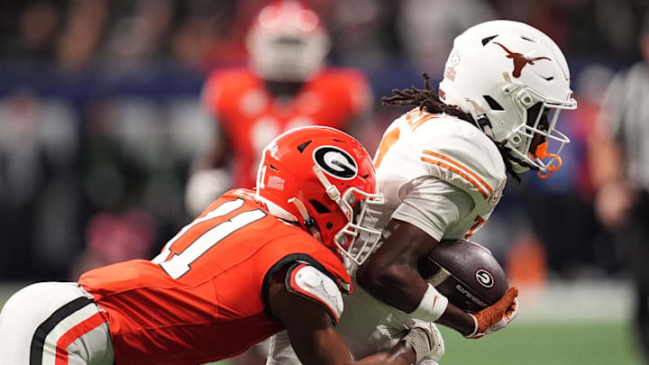 Dec 7, 2024; Atlanta, GA, USA; Texas Longhorns wide receiver Silas Bolden (11) makes a catch agaistn Georgia Bulldogs linebacker Jalon Walker (11) during the first half in the 2024 SEC Championship game at Mercedes-Benz Stadium. Mandatory Credit: Dale Zanine-Imagn Images