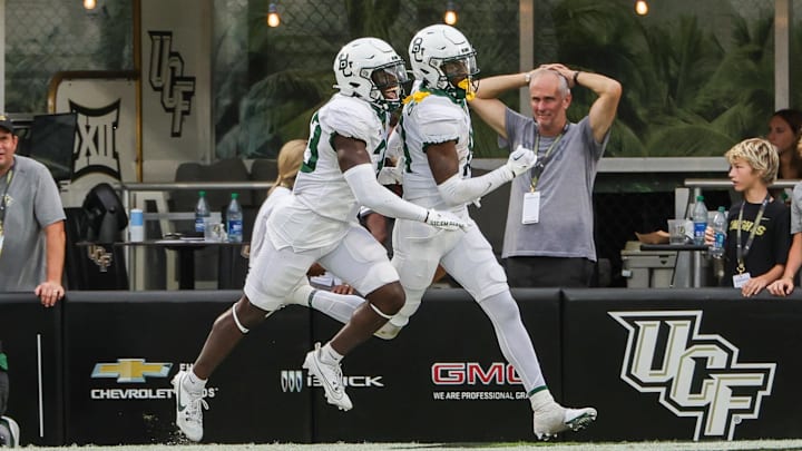 Sep 30, 2023; Orlando, Florida, USA; Baylor Bears cornerback Caden Jenkins (19) celebrates his touchdown with a teammate during the second half against the UCF Knights at FBC Mortgage Stadium. Mandatory Credit: Mike Watters-Imagn Images