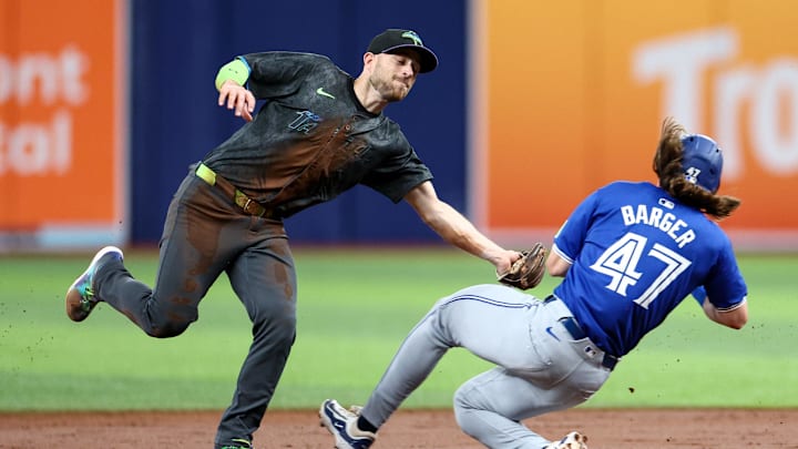 Sep 21, 2024; St. Petersburg, Florida, USA; Tampa Bay Rays second baseman Brandon Lowe (8) attempts to tag Toronto Blue Jays outfielder Addison Barger (47) in the first inning at Tropicana Field. Mandatory Credit: Nathan Ray Seebeck-Imagn Images