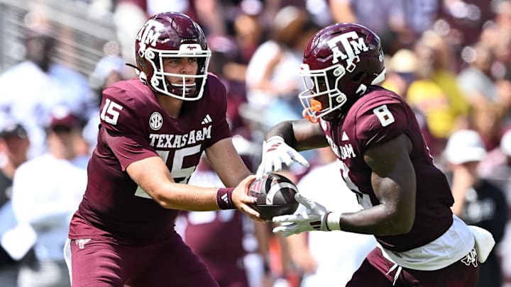 Oct 5, 2024; College Station, Texas, USA; Texas A&M Aggies quarterback Conner Weigman (15) hand off the ball to running back Le'Veon Moss (8) in the second half against the Missouri Tigers at Kyle Field. Mandatory Credit: Maria Lysaker-Imagn Images. 