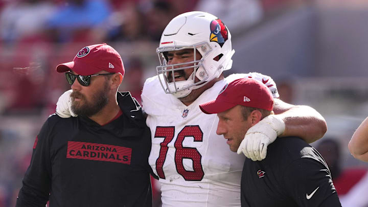Oct 6, 2024; Santa Clara, California, USA; Arizona Cardinals guard Will Hernandez (76) is helped off of the field by medical personnel after suffering an injury during the fourth quarter against the San Francisco 49ers at Levi's Stadium. Mandatory Credit: Darren Yamashita-Imagn Images Oct 6, 2024; Santa Clara, California, USA; Arizona Cardinals guard Will Hernandez (76) is helped off of the field by medical personnel after suffering an injury during the fourth quarter against the San Francisco 49ers at Levi's Stadium. Mandatory Credit: Darren Yamashita-Imagn Images