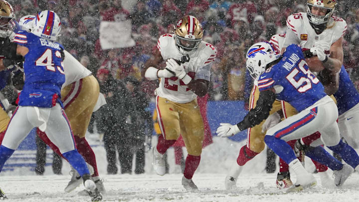 Dec 1, 2024; Orchard Park, New York, USA; San Francisco 49ers running back Jordan Mason (24) runs with the ball against the Buffalo Bills during the first half at Highmark Stadium. Mandatory Credit: Gregory Fisher-Imagn Images