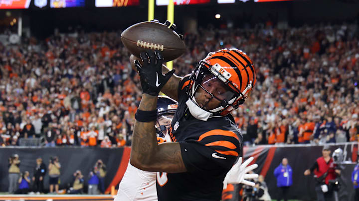 Dec 28, 2024; Cincinnati, Ohio, USA;  Cincinnati Bengals  wide receiver Tee Higgins (5) catches a touchdown as Denver Broncos cornerback Riley Moss (21) defends during the fourth quarter at Paycor Stadium. Mandatory Credit: Joseph Maiorana-Imagn Images