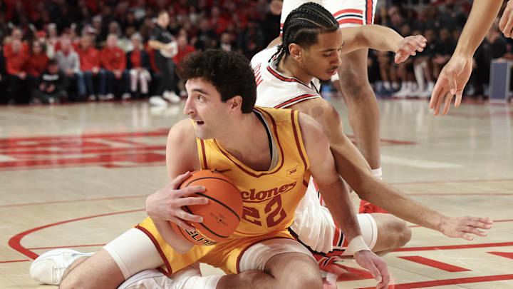 Feb 22, 2025; Houston, Texas, USA; Iowa State Cyclones forward Milan Momcilovic (22) grabs a rebound against Houston Cougars guard Milos Uzan (7) in the first half at Fertitta Center. Mandatory Credit: Thomas Shea-Imagn Images