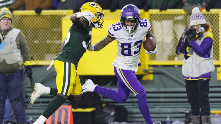 Jan 1, 2023; Green Bay, Wisconsin, USA;  Minnesota Vikings wide receiver Jalen Nailor (83) rushes for a touchdown as Green Bay Packers cornerback Corey Ballentine (35) defends during the fourth quarter at Lambeau Field. Mandatory Credit: Jeff Hanisch-USA TODAY Sports