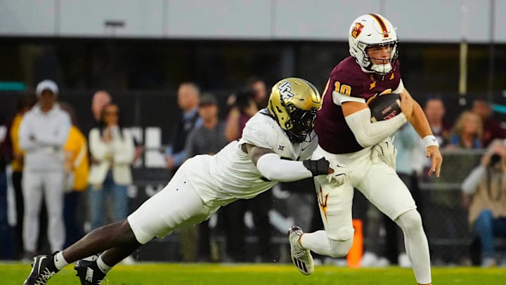 UCF defensive end Malachi Lawrence (51) tackles ASU quarterback Sam Leavitt (10) as he scrambles during a game at Mountain America Stadium in Tempe on Nov. 9, 2024. UCF defensive end Malachi Lawrence (51) tackles ASU quarterback Sam Leavitt (10) as he scrambles during a game at Mountain America Stadium in Tempe on Nov. 9, 2024.