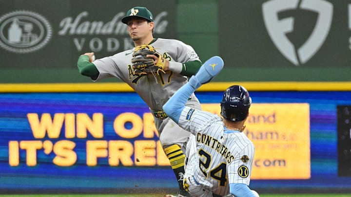 Apr 20, 2025; Milwaukee, Wisconsin, USA; Athletics third baseman Luis Urias (17) completes a double play after forcing out Milwaukee Brewers designated hitter William Contreras (24) during the sixth inning at American Family Field. Mandatory Credit: Patrick Gorski-Imagn Images