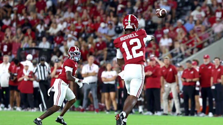 Sep 6, 2025; Tuscaloosa, Alabama, USA; Alabama Crimson Tide quarterback Keelon Russell (12) throws a pass to wide receiver Jaylen Mbakwe (3) during the second half against the Louisiana Monroe Warhawks at Saban Field at Bryant-Denny Stadium.